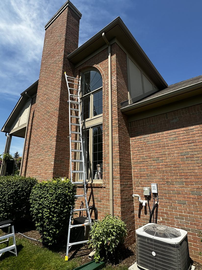 Elite Shine ladder setup for exterior window cleaning
